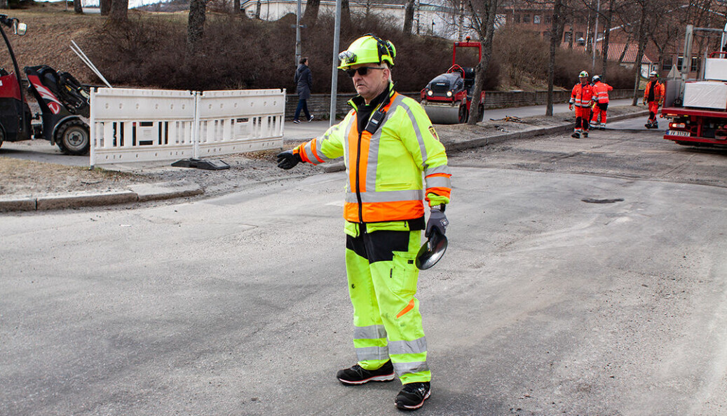 Dirigerer trafikk: Odd Erik Sandmo fra TrafikkDirigering AS sørger for at bilistene kommer seg trygt forbi mens det asfalteres